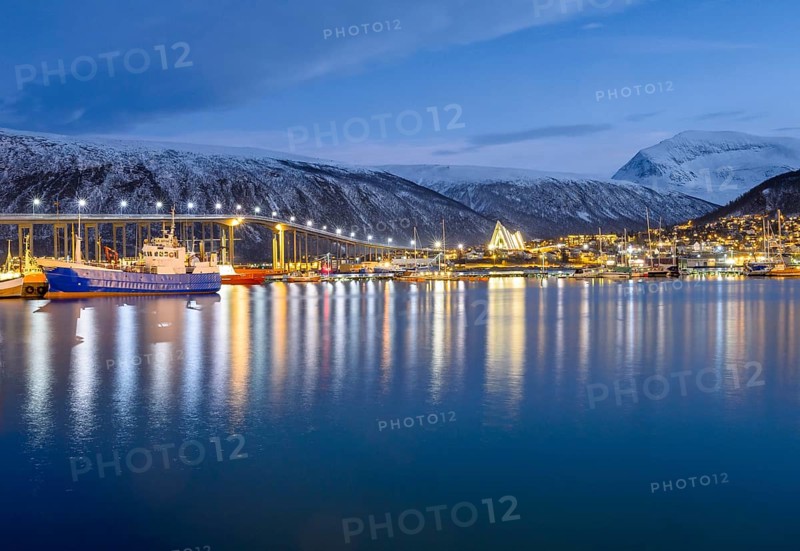 View over the harbour and city with Tromsobrua or Tromso Bridge