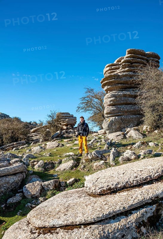 Young man standing on rocks