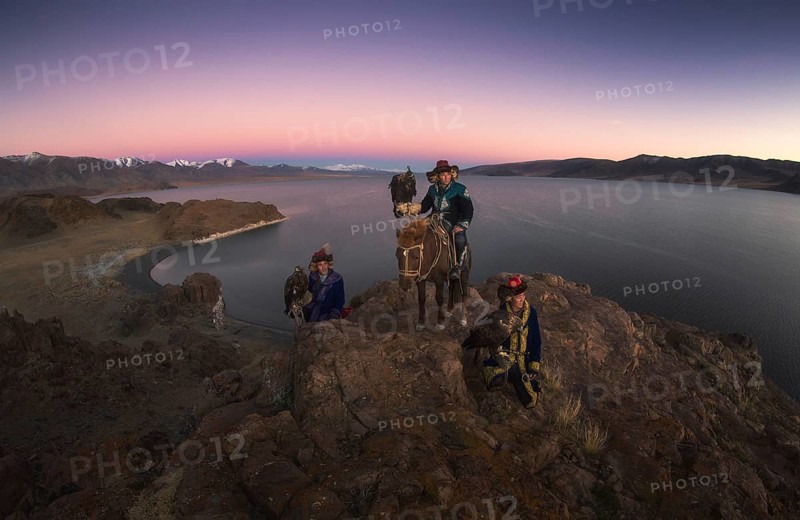 Eagle hunters with their trained eagles in Tolbo lake. Bayan-Ulgii province