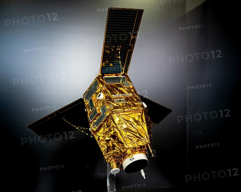 Model of a satellite with solar panel and golden heat protection foil
