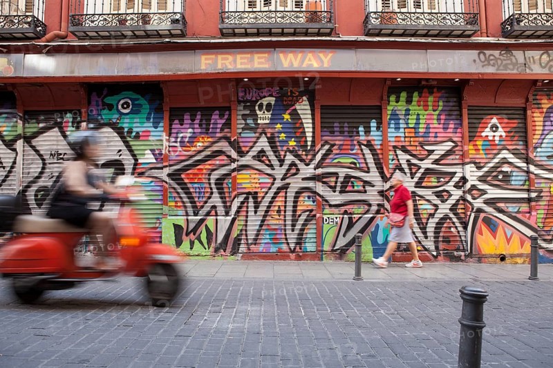 Row of shops with graffiti in the Malasana district