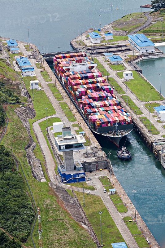 Aerial view of Neo-Panamax container ship crossing the third set of locks at the pacific side