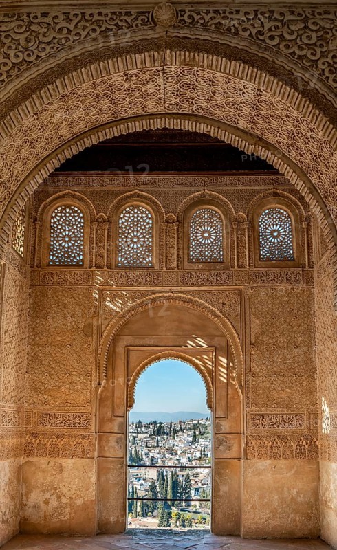 View of the Albayzin district through arched windows decorated with arabesques