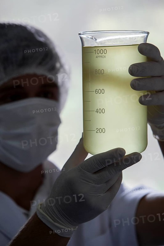 Employee measures rosemary oil at the cosmetics factory in Itupeva