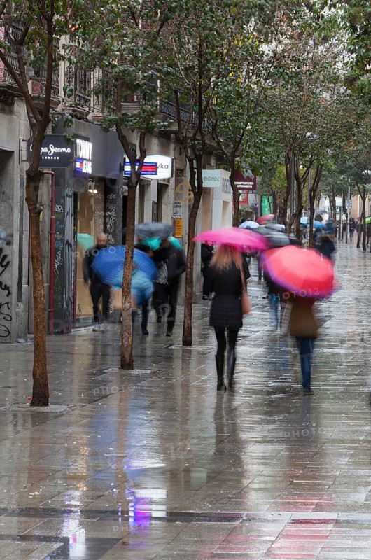 Residents and tourists walk by the most famous Fuencarral street