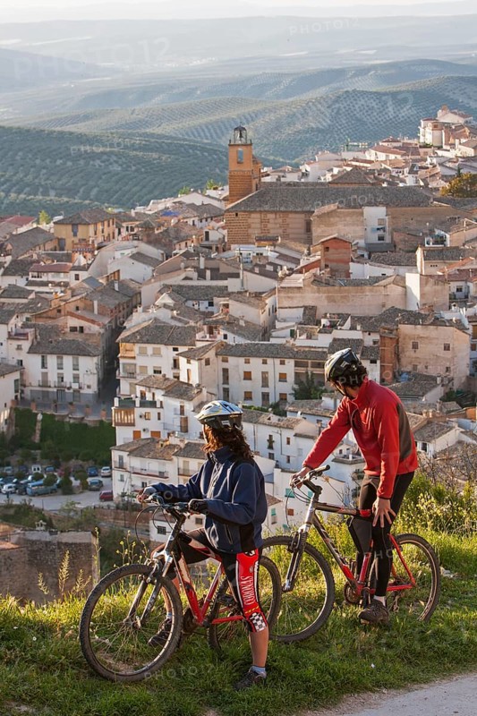 Two mountain bikers observe the village of Cazorla