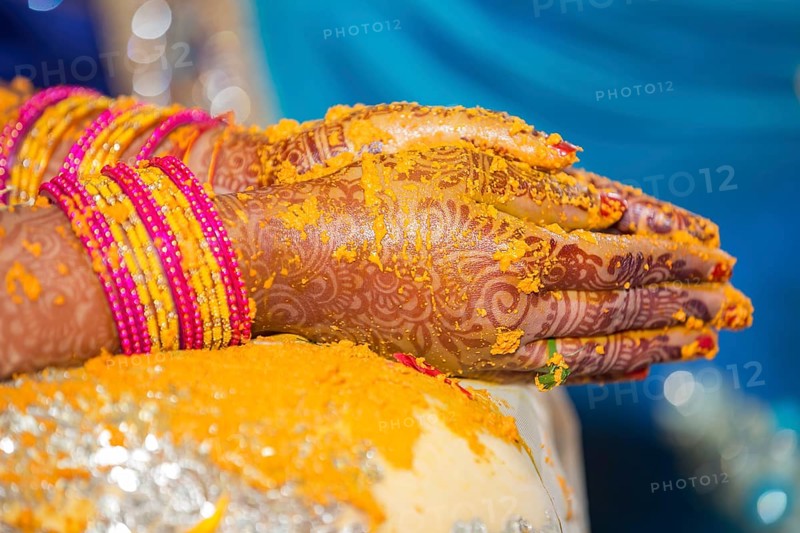 Hindu Bride crossing hands painted with henna for prayer on wedding eve