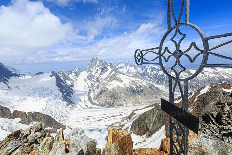 Oberaarhorn summit cross with view of Finsteraargletscher