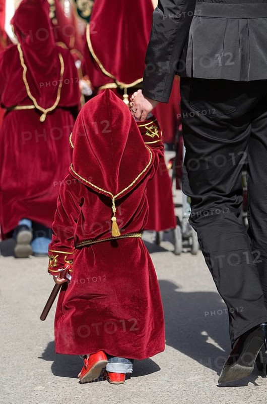 Child in penitential attire in the procession for Holy Week in Baeza