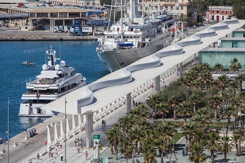 Luxury yachts and Palmeral De Las Sorpresas in the port of Malaga