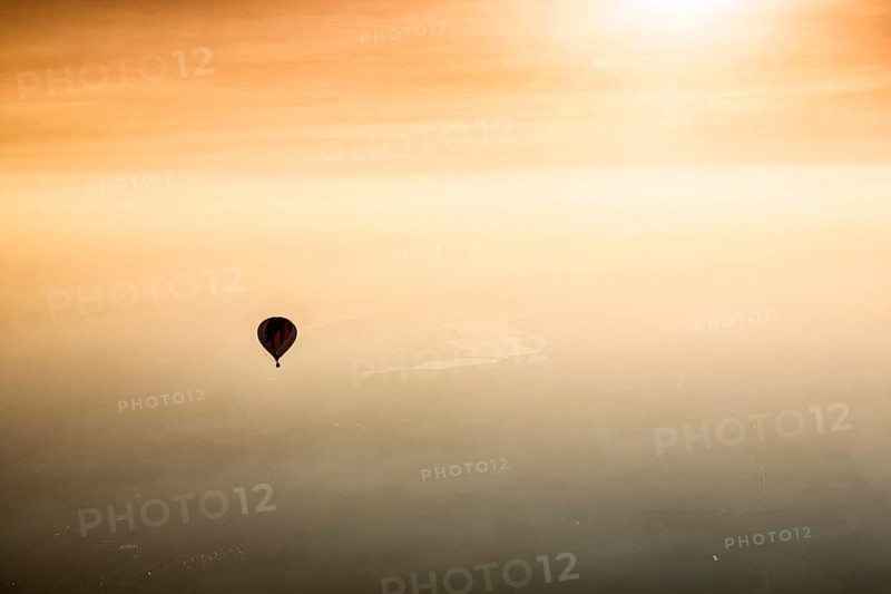 Hot air balloon rides towards sunset