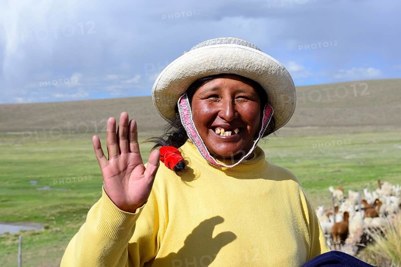 Indigenous woman waves into the camera
