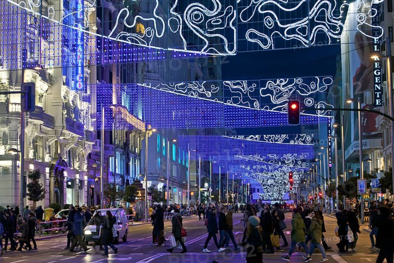 Pedestrians in La Gran Via with Christmas lights