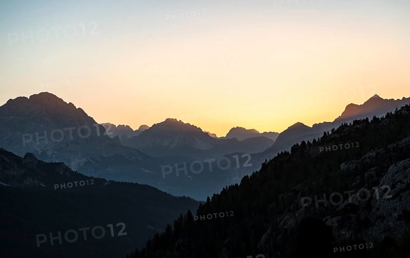 Sunrise in front of mountain silhouette