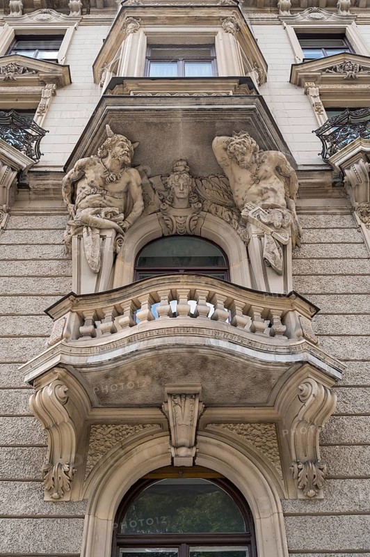 Baroque facade with balconies and 2 atlases