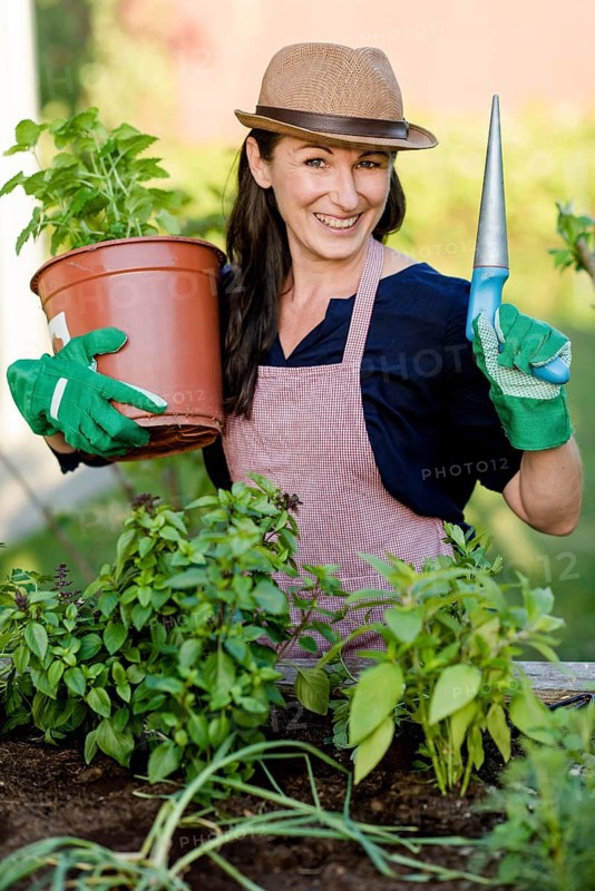 Woman doing gardening on a raised bed