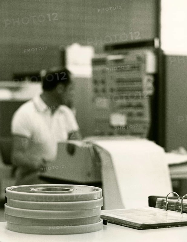 Programmer at the printer in front of the input head