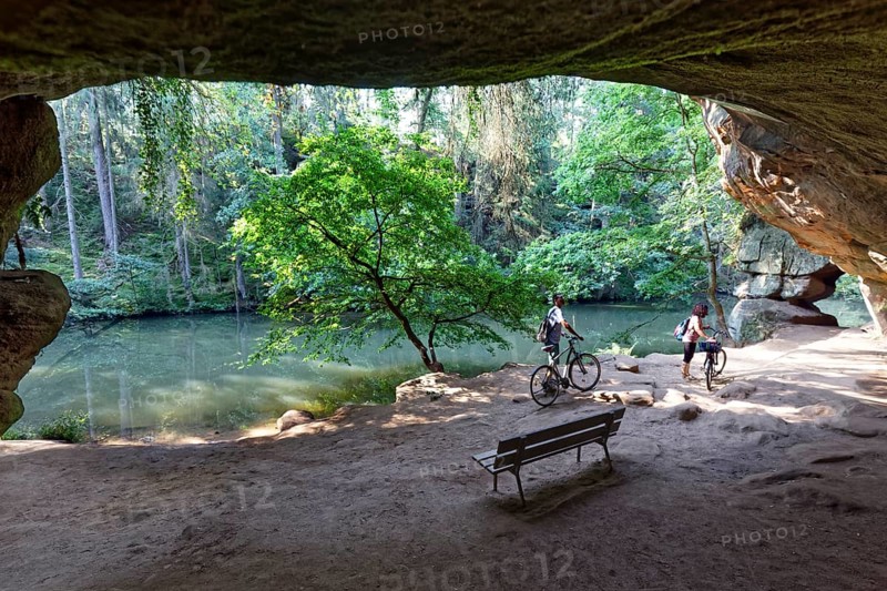 Bank and cyclist in front of Gutav Adolf cave