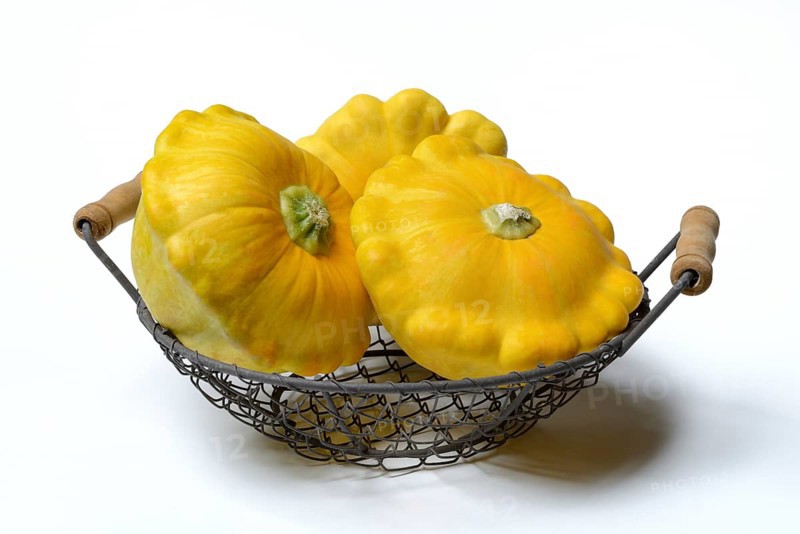 Yellow patisson pumpkins in wire basket
