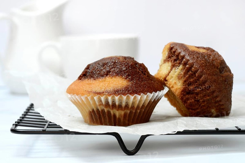 Two chocolate muffins on cake grid