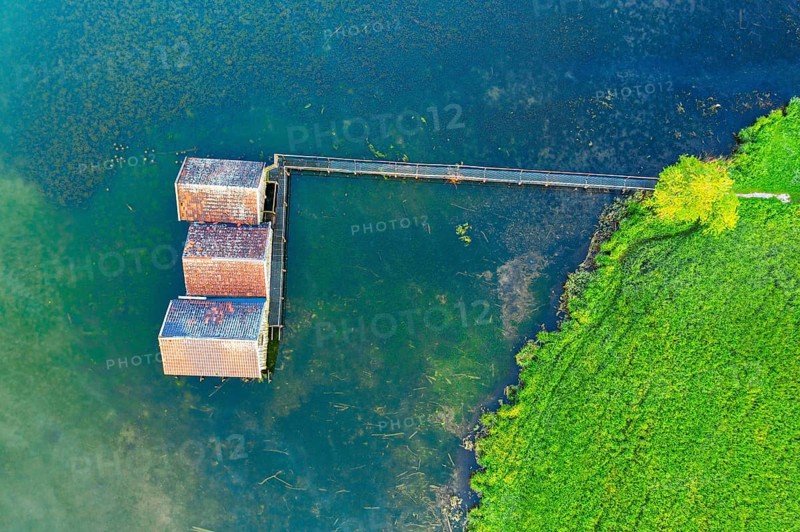 Boathouses in Lake Kochel near Schlehdorf from above