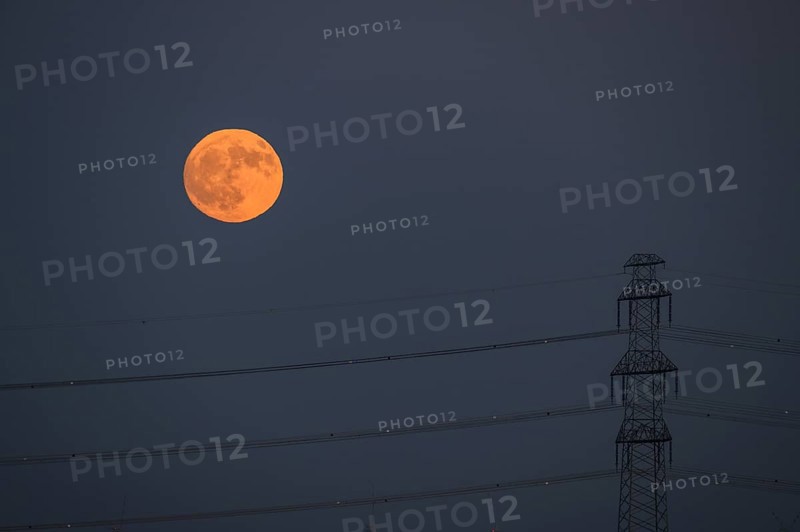 Power pole with full moon