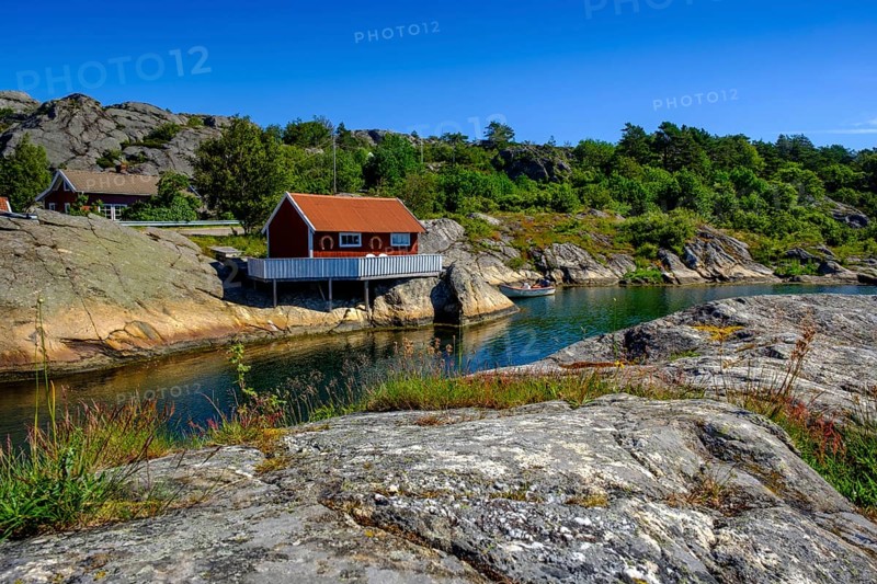 Red cottage by the water