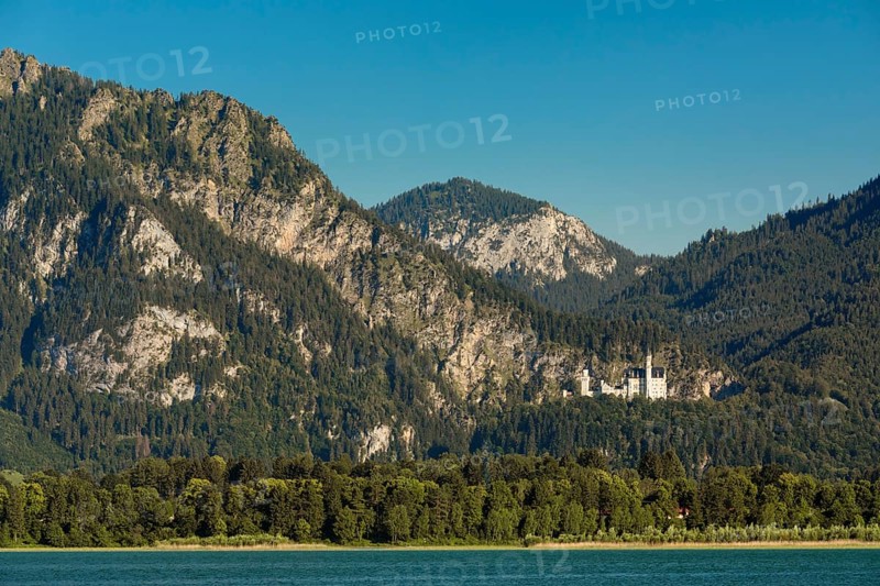 View over the Forgensee to Neuschwanstein Castle and the Tannheimer Mountains