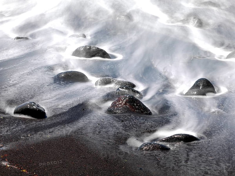Black stones and sand