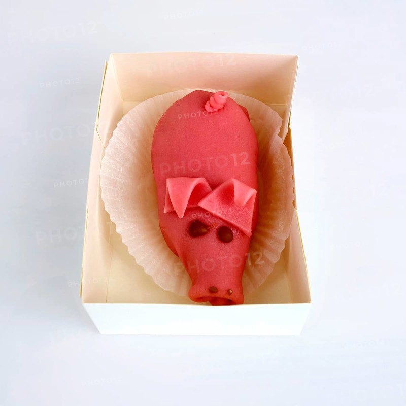 Marzipan pig in a box of pastry