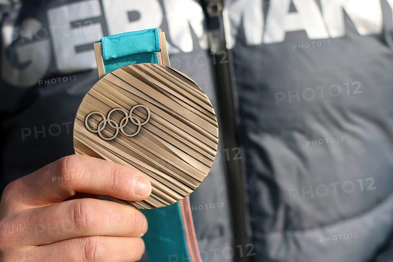 Bronze medal in the hands of an athlete