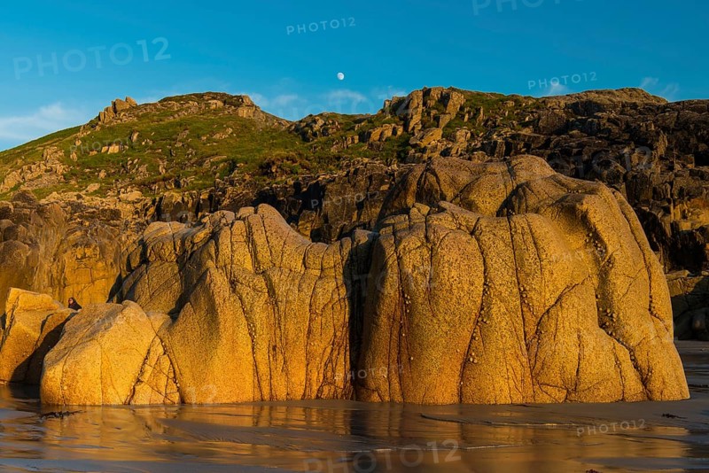 Moon above the rocky coast at Porth Nanven