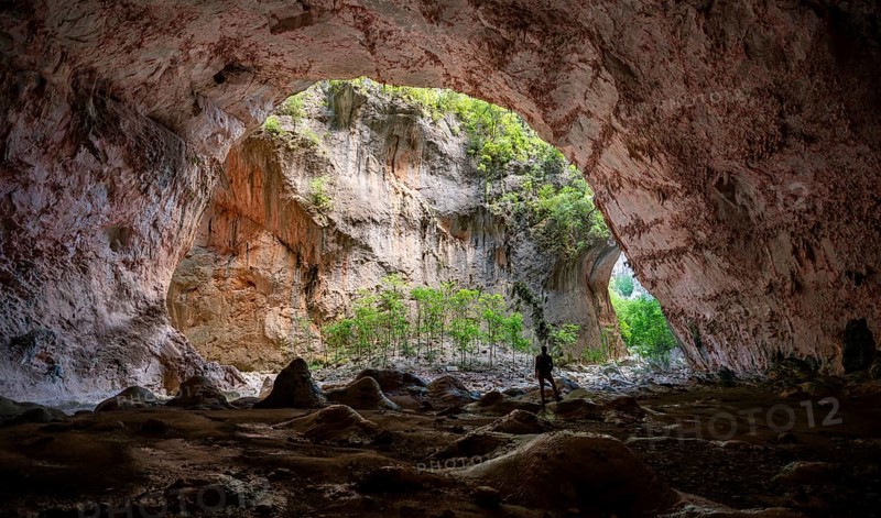 Hiker stands in the cave Cueva de La Ermita