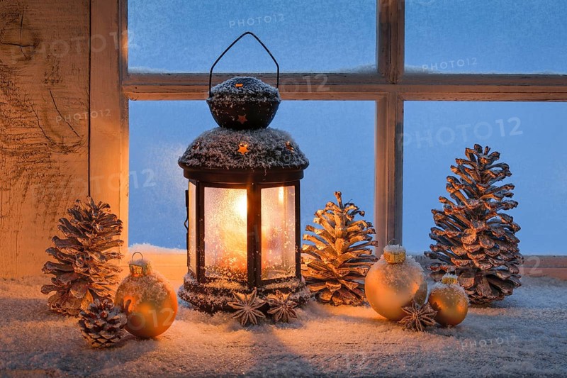 Lantern with Christmas decoration on windowsill