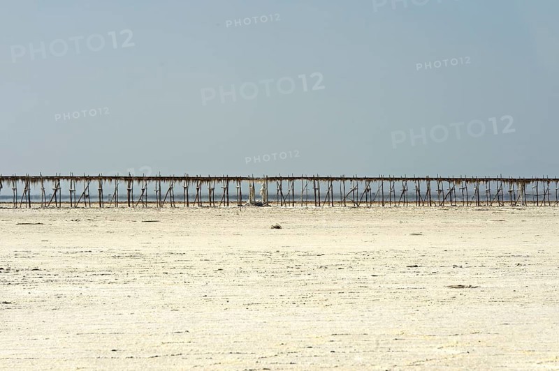 Pipeline on stilts on the Assale Salt Lake for the transport of brine to the evaporation basins of a salt works