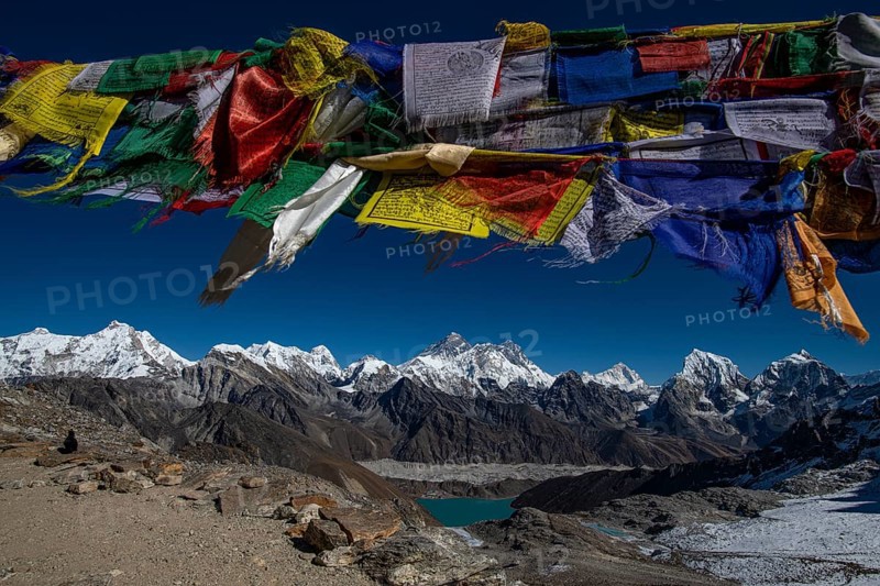 View with Buddhist prayer flags from Renjo La Pass 5417m to the east to Himalaya with Pumori