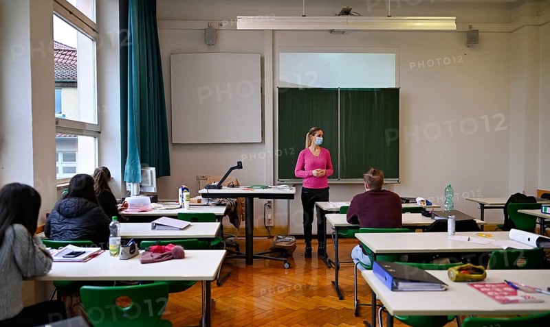 Teacher with face mask in classroom