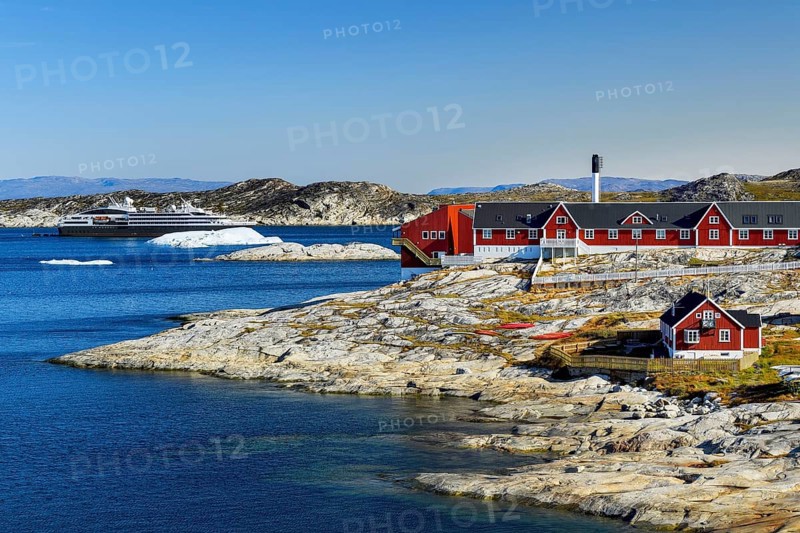 Colourful houses with view into Disko Bay to the cruise ship Ponant