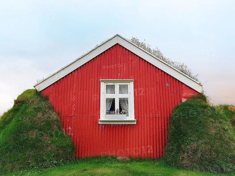 Traditional peat house Lindarbakki with red gable wall