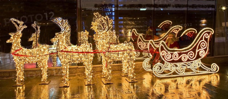 Electric sculptures of golden deers and carriage with Santa Claus