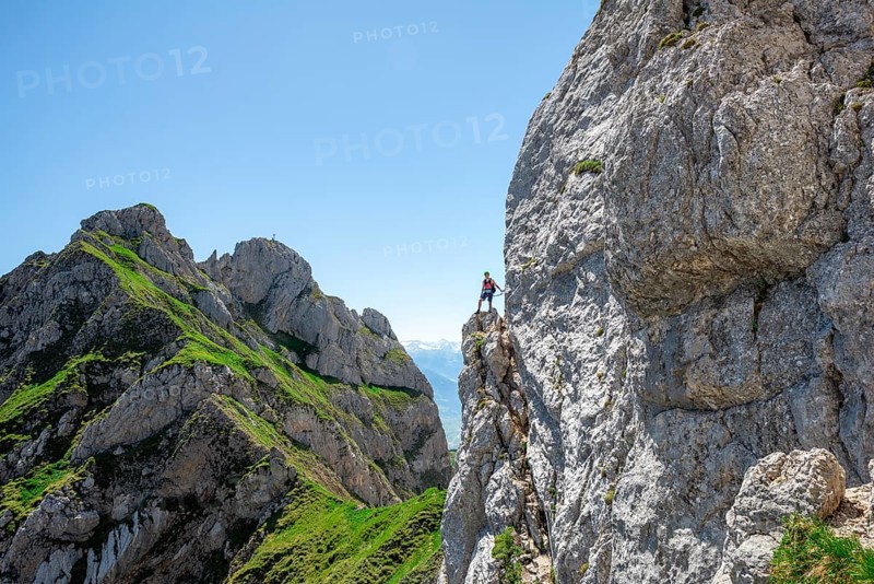 Young man climbing a rock face