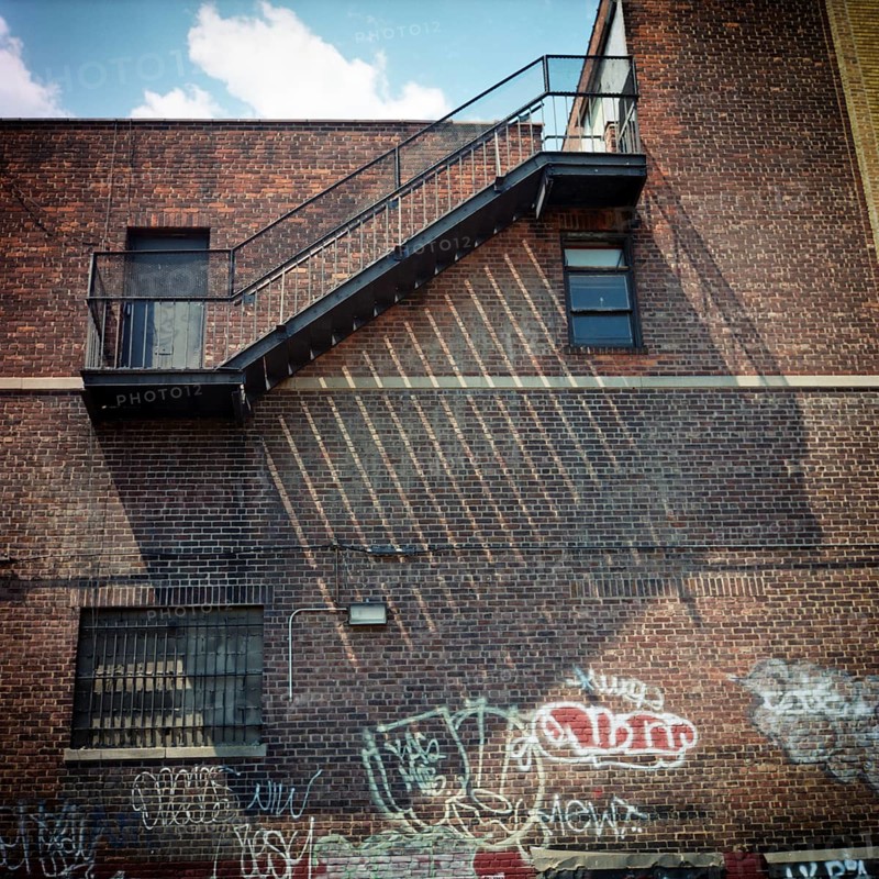 Fire wall and fire escape at noon light
