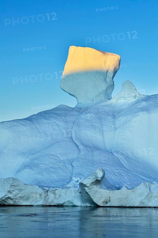 Evening atmosphere with sunlit iceberg