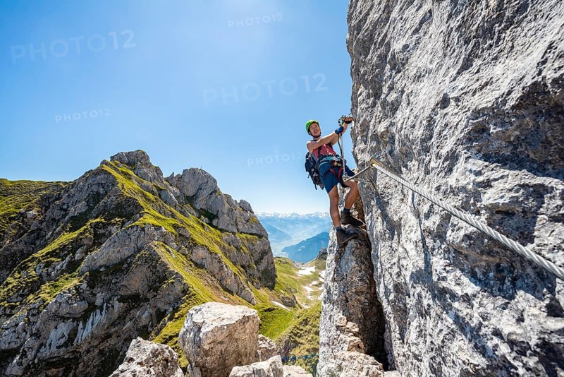 Young man climbing a rock face
