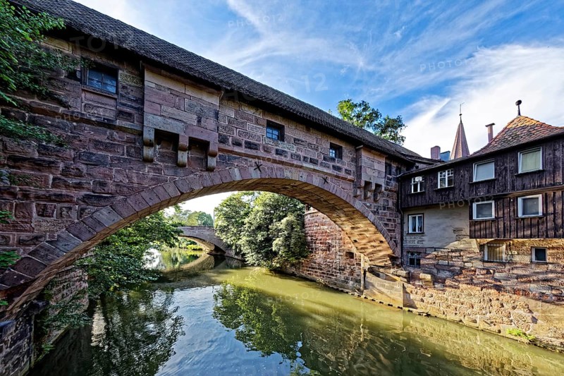 View from Kettensteg to Fronveste and Hallertor bridge over the river Pegnitz