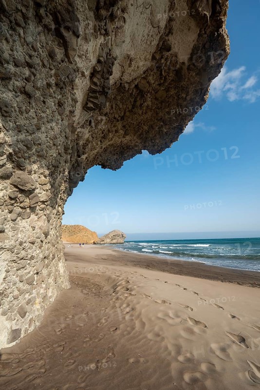 Petrified lava tongues and rocky coast at the beach Playa del Monsul