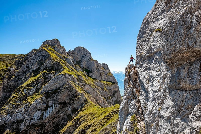 Young man climbing a rock face