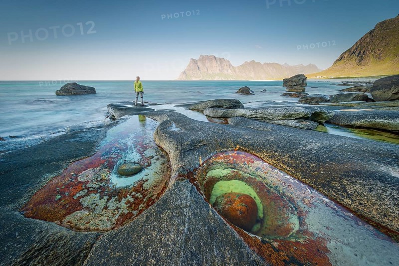 Woman standing on rocks on the beach