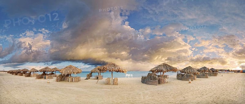 Sandy beach beach with umbrellas at the coral reef Abu-Dabbab