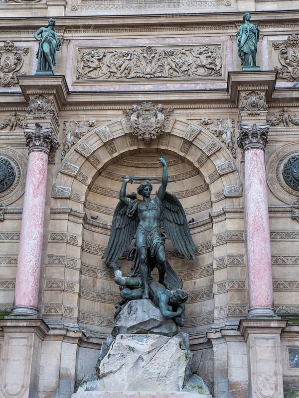 Bronze statue of the fountain La Fontaine Saint Michel at Place Saint-Michel